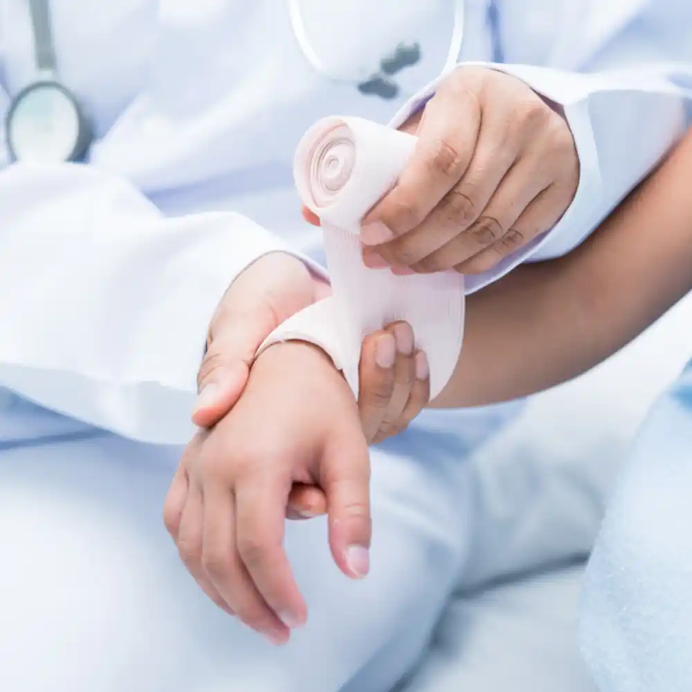 greyledge-bone-injury_1 A ortho doctor wrapping a patient’s wrist, after Bone Injury treatment in Miami, FL.