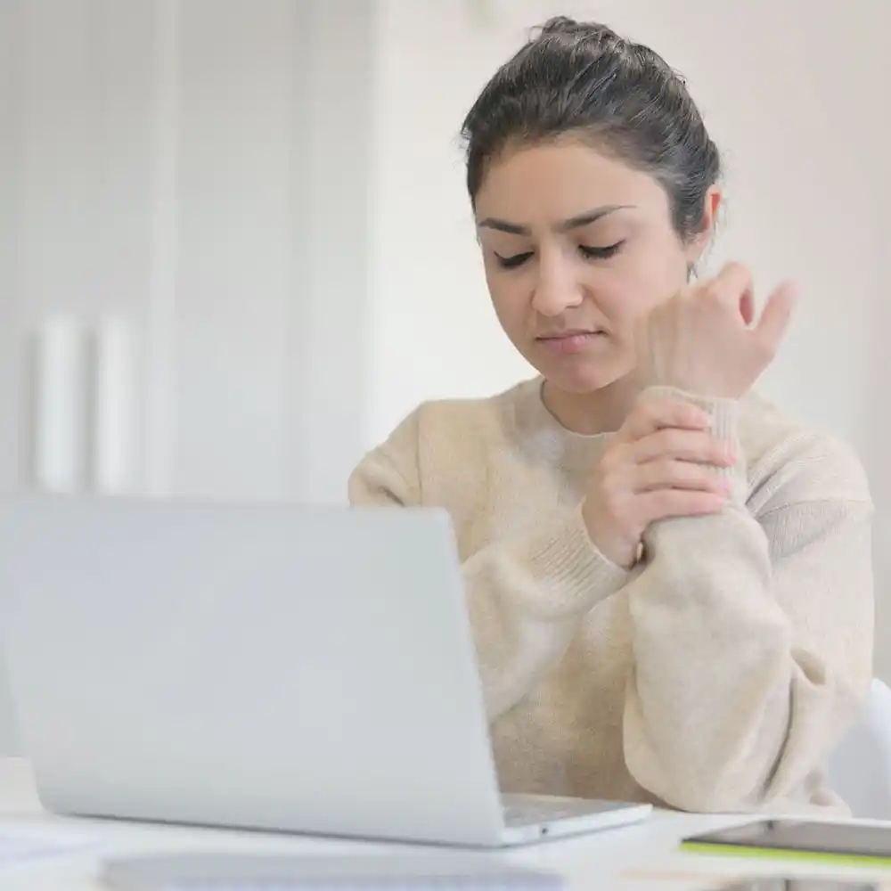 neurology_img A woman holding her wrist in pain, focusing on Nerve Injury Treatment in Miami, FL.