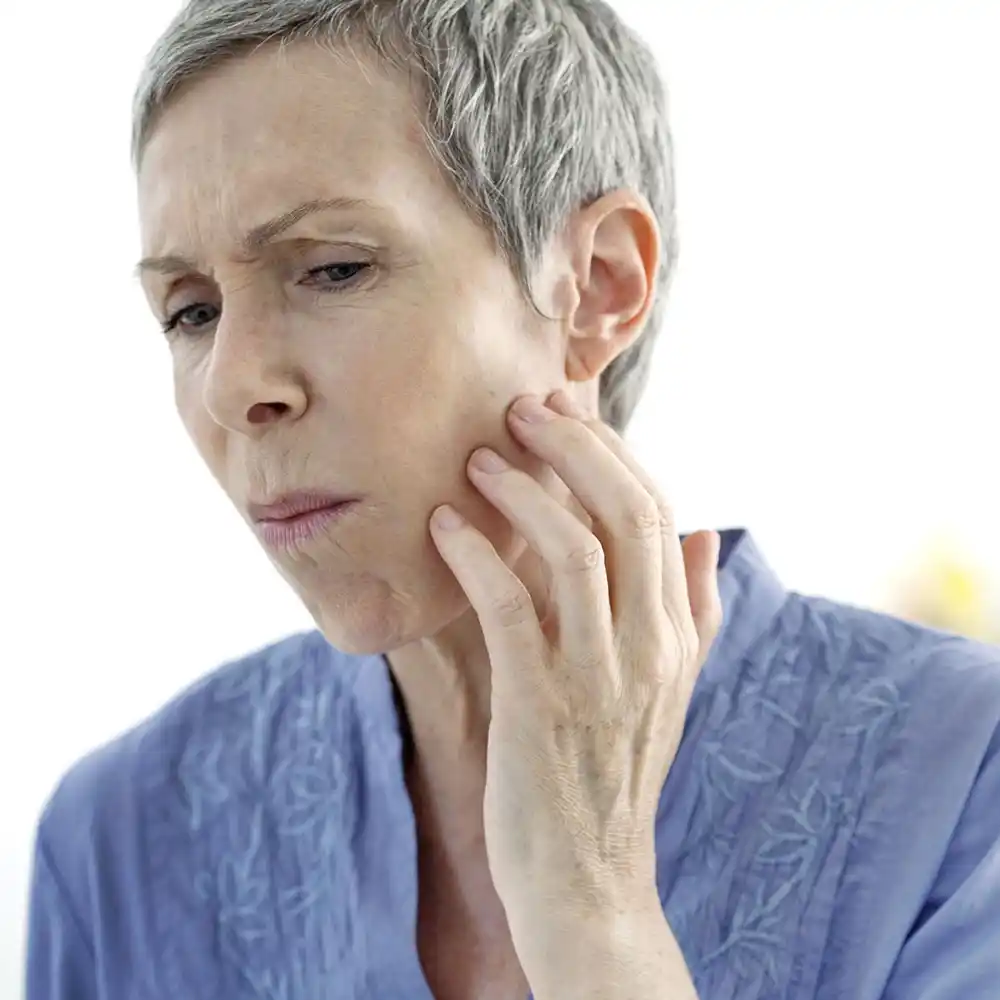 oral_img A person touching their face in pain, needs Oral and Maxillofacial Surgery at Greyledge Technologies, Miami, FL.