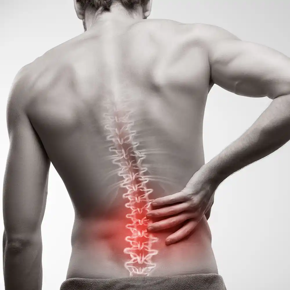 spinal_img A man holding his lower back in pain with a highlighted spine, showcasing Spinal Pain and Fractures at Greyledge Technologies, Miami, FL.